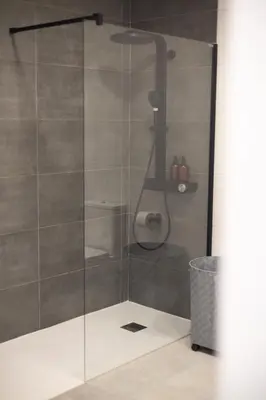 a shower with a glass door in a bathroom at Camino Termal OURENSE in Valenzana