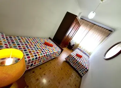 a small bedroom with a bed and a window at Apartamento Playa Foz 4 Dormitorios in Foz