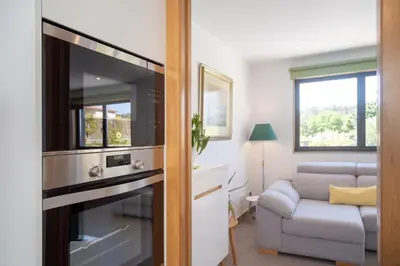 a living room with a couch and a television at Casa Folgoso in Santiago de Compostela