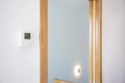 a lightswitch on a wall next to a mirror at Casa Folgoso in Santiago de Compostela