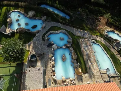 an aerial view of a building with blue windows at Hermosa casa en entorno termal in Pungín