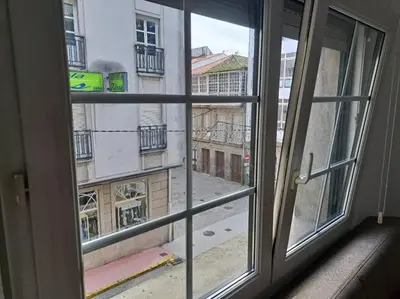 an open window with a view of a city street at Habitación privada en el mismo Camino de Santiago in Caldas de Reis