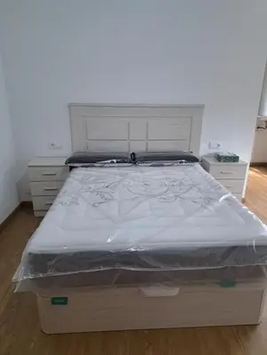a bed in a bedroom with a white bed frame at Habitación privada en el mismo Camino de Santiago in Caldas de Reis