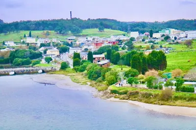 a small town next to a river with houses at Atico Deluxe Limosa romántico moderno junto al mar in San Ciprián