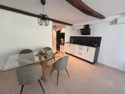 a dining room with a glass table and chairs at Tinería Lux in Lugo
