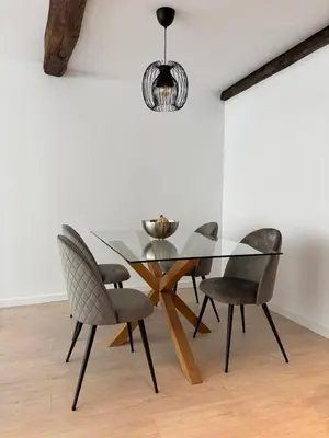 a dining room with a glass table and chairs at Tinería Lux in Lugo