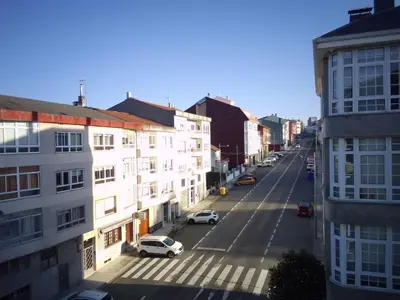 a view of a city street with cars parked on the street at Road in Palas de Rei