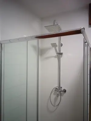 a desk in a room with a glass shower stall at Road in Palas de Rei