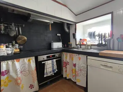 a kitchen with a sink and a stove top oven at Relax & Vistas, casa en la roca in Rogüela
