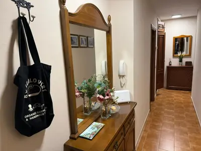 a bathroom with a mirror and a dresser with a purse at Piso vacacional en Ribadeo in Ribadeo