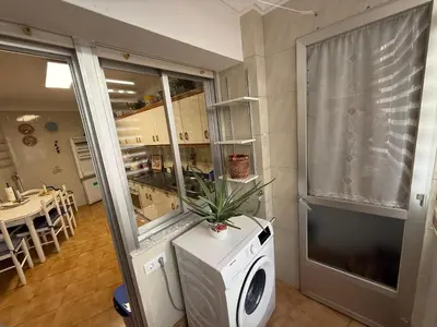 a kitchen with a washing machine in a room at Piso vacacional en Ribadeo in Ribadeo