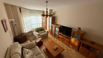 a living room with a couch and a tv at Piso vacacional en Ribadeo in Ribadeo