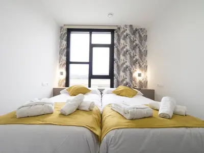 two beds with pillows on them in a bedroom at Pensión Spa Cruceiro de Pedrouzo in O Pedrouzo