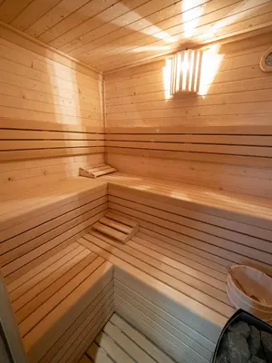 a small wooden sauna with a light on at Pensión Spa Cruceiro de Pedrouzo in O Pedrouzo