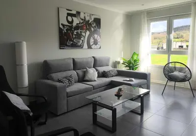 a living room with a couch and a table at Xabarin Apart II in Abadín