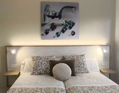 a bed with a head board with a light above it at Xabarin Apart II in Abadín