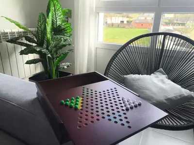 a table with a game on it next to a chair at Xabarin Apart II in Abadín