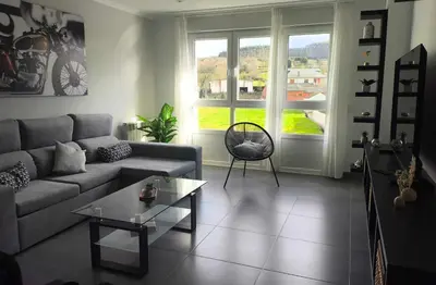a living room with a couch and a table at Xabarin Apart II in Abadín