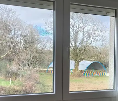 two windows in a room with a view of a playground at Xabarin Apart II in Abadín
