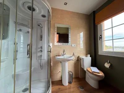 a bathroom with a shower and a sink and a toilet at Pensión Restaurante Tino in Germade