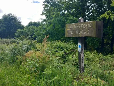 a wooden sign in the middle of a field at A casa da Cernada in Rocas
