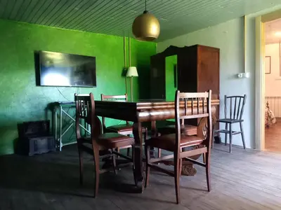 a dining room with green walls and a table and chairs at A casa da Cernada in Rocas