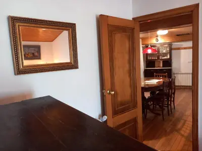a dining room with a table and a mirror on the wall at A casa da Cernada in Rocas