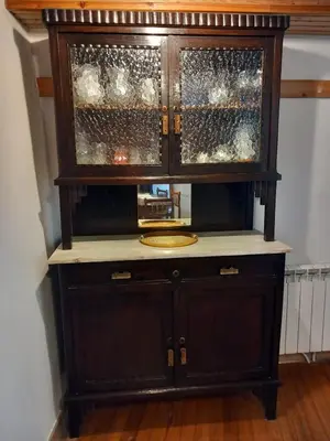 a wooden cabinet with glass doors in a room at A casa da Cernada in Rocas