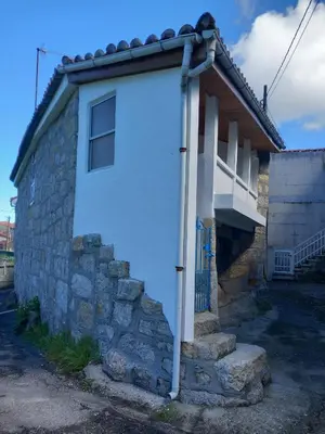 a white door on the side of a house at A casa da Cernada in Rocas