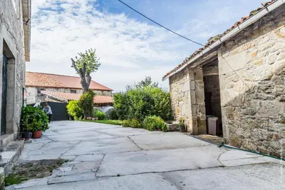 an alleyway between two buildings in an old building at Casa do Ferrador in Penasillás