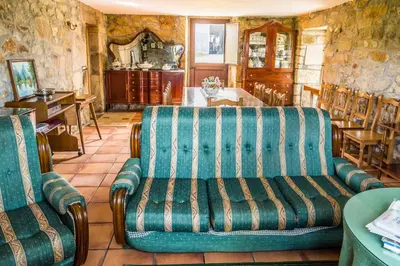 a living room with a couch and a table at Casa do Ferrador in Penasillás