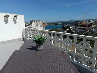 a potted plant sitting on a bench on a balcony at A Torre in Ribadeo