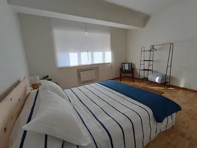 a large bed in a room with a window at A Torre in Ribadeo