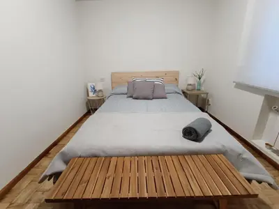 a bedroom with a large bed and a wooden floor at A Torre in Ribadeo
