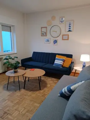 a living room with a blue couch and a table at A Torre in Ribadeo
