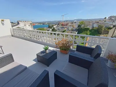 a balcony with furniture and a view of the city at A Torre in Ribadeo