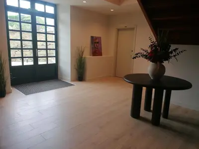 a living room with a table and a vase on it at U-Hotel Aduana Ribadeo in Ribadeo