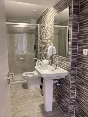 a bathroom with a sink and a toilet and a mirror at Albergue o Bailarin in O Barco de Valdeorras