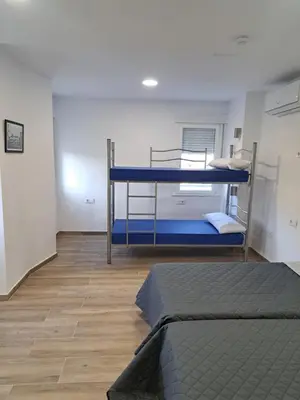 a room with two bunk beds in it at Albergue o Bailarin in O Barco de Valdeorras