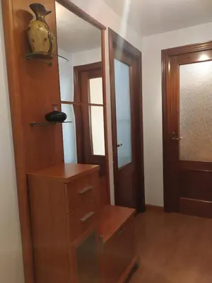 a dressing room with a wooden cabinet and a mirror at La Niña in Tineo