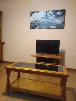 a table with a flat screen tv on top of it at La Niña in Tineo