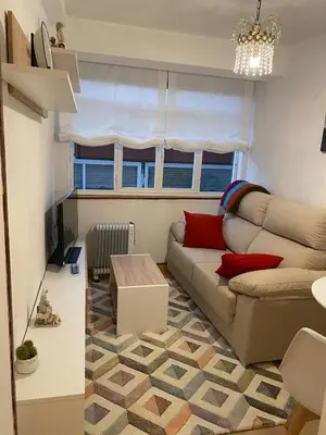 a living room with a couch and a table at Casa centro histórico de Viveiro in Viveiro
