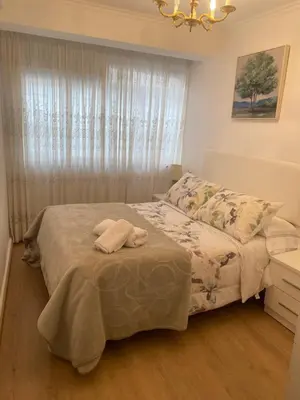 a bedroom with a bed with blue towels on it at Casa centro histórico de Viveiro in Viveiro