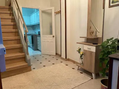 a hallway with a staircase and a door to a room at Casa centro histórico de Viveiro in Viveiro