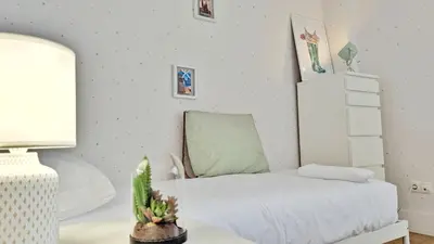 a bedroom with a bed and a table with a lamp at Casa con piscina Riosar Santiago in Amés