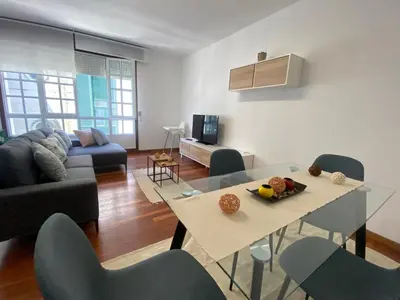 a living room with a table and chairs and a couch at A dos Pasos in Caldas de Reis