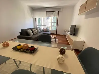 a living room with a table and a couch at A dos Pasos in Caldas de Reis