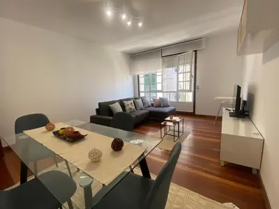 a living room with a table and a couch at A dos Pasos in Caldas de Reis