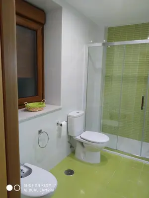 a bathroom with a toilet and a glass shower at Casa Pura in Ribadeo