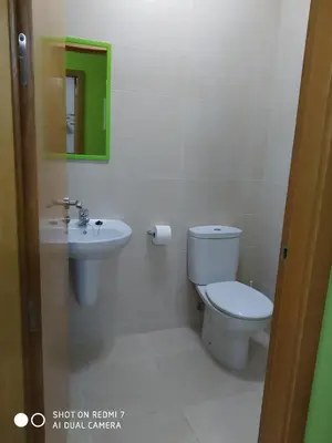 a bathroom with a toilet and a sink at Casa Pura in Ribadeo